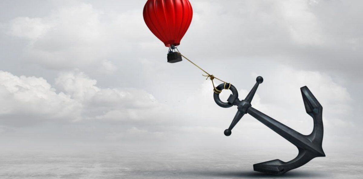 dealing with a difficult board member - A cloudy sky with a red hot air balloon attempting to fly off but is being tied down by an oversized anchor.