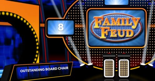 Board Chair - Family Feud stage with two podiums, Outstanding Board Chair as the name of the team, and a scoreboard with the number 8.
