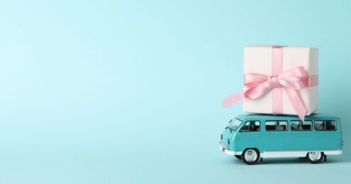 Image of a gift on top of a bus representing getting the right people on "your bus". nonprofit talent management