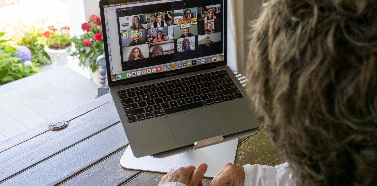 Laptop showing the Joan Garry team working remotely.
